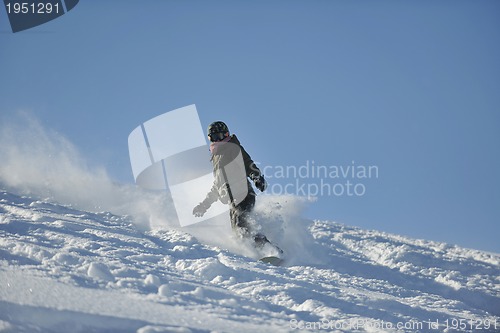 Image of freestyle snowboarder jump and ride