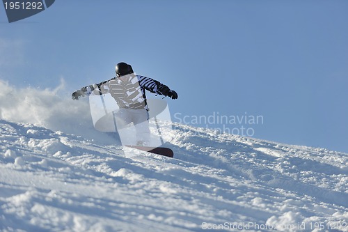 Image of freestyle snowboarder jump and ride