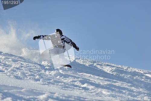 Image of freestyle snowboarder jump and ride