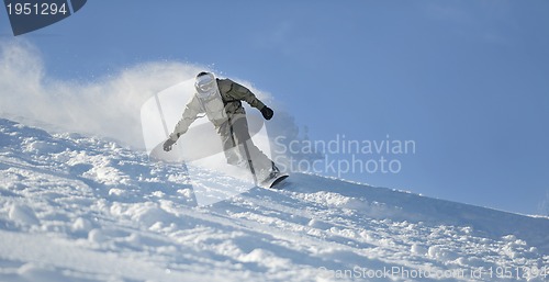 Image of freestyle snowboarder jump and ride