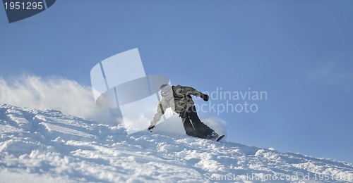 Image of freestyle snowboarder jump and ride