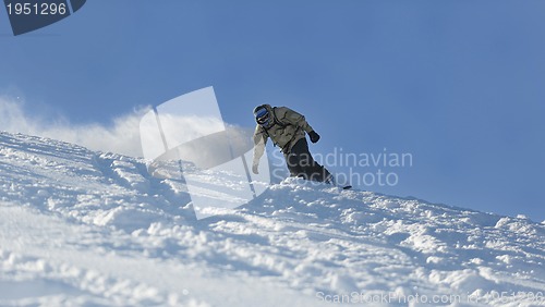 Image of freestyle snowboarder jump and ride