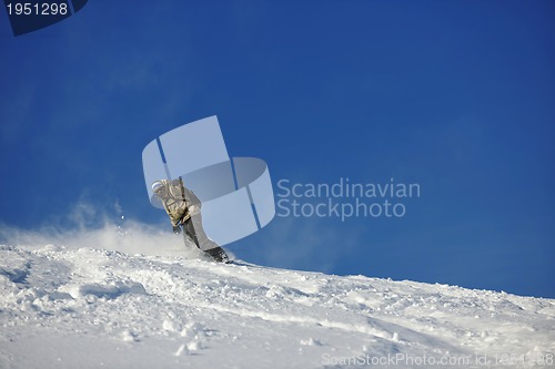 Image of freestyle snowboarder jump and ride