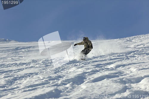 Image of freestyle snowboarder jump and ride