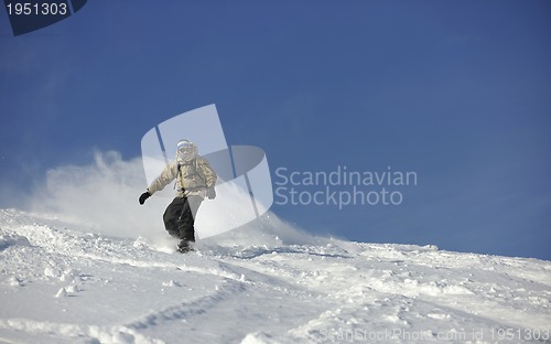 Image of freestyle snowboarder jump and ride