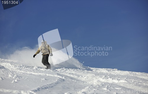 Image of freestyle snowboarder jump and ride