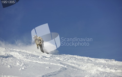 Image of freestyle snowboarder jump and ride