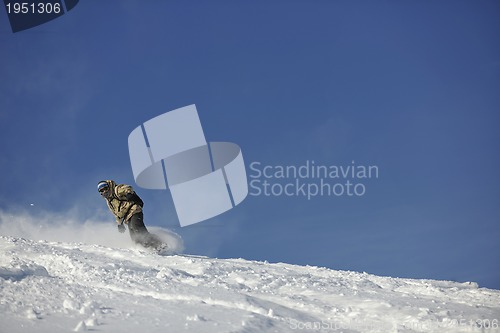 Image of freestyle snowboarder jump and ride