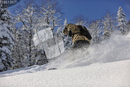 Image of freestyle snowboarder jump and ride