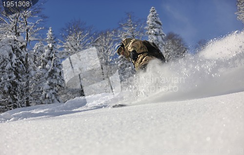 Image of freestyle snowboarder jump and ride