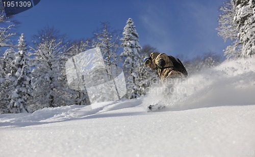 Image of freestyle snowboarder jump and ride