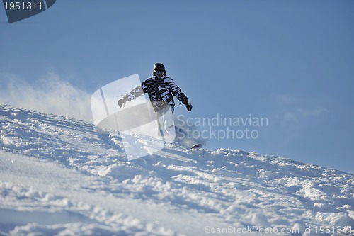 Image of freestyle snowboarder jump and ride