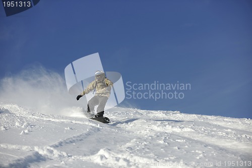 Image of freestyle snowboarder jump and ride