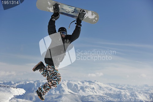 Image of freestyle snowboarder jump and ride