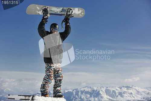Image of freestyle snowboarder jump and ride