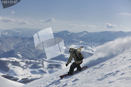 Image of freestyle snowboarder jump and ride