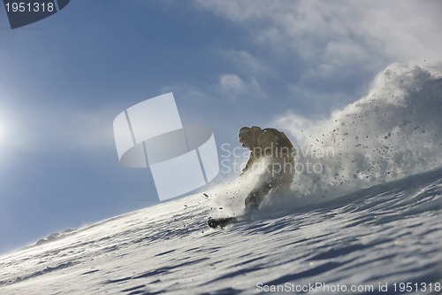 Image of freestyle snowboarder jump and ride