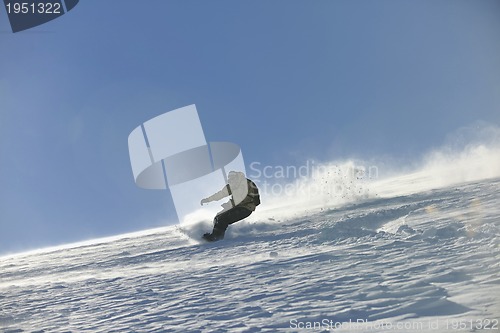 Image of freestyle snowboarder jump and ride
