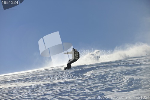 Image of freestyle snowboarder jump and ride