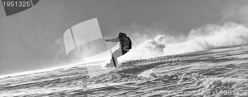 Image of freestyle snowboarder jump and ride