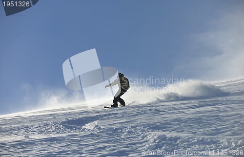 Image of freestyle snowboarder jump and ride