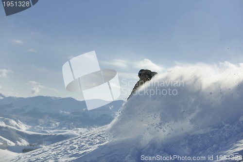 Image of freestyle snowboarder jump and ride