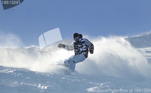 Image of freestyle snowboarder jump and ride