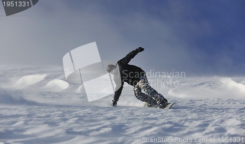 Image of freestyle snowboarder jump and ride