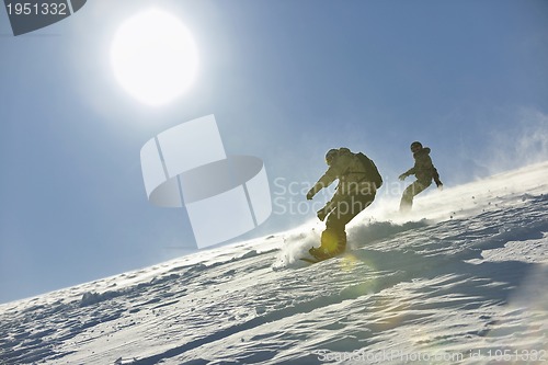 Image of freestyle snowboarder jump and ride