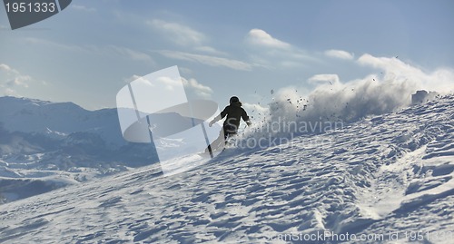 Image of freestyle snowboarder jump and ride