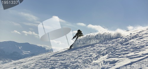 Image of freestyle snowboarder jump and ride