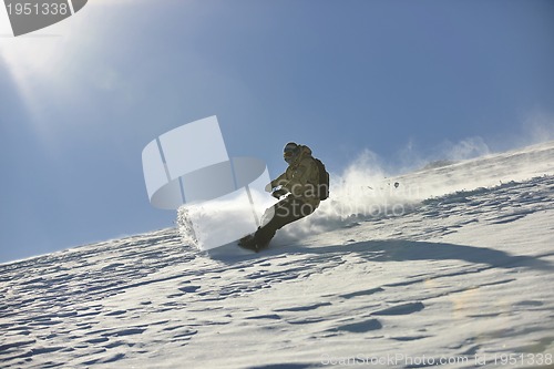 Image of freestyle snowboarder jump and ride