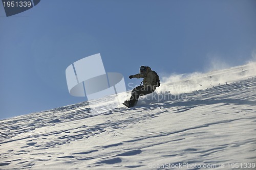 Image of freestyle snowboarder jump and ride