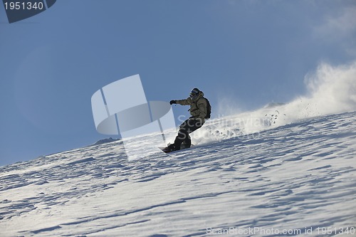 Image of freestyle snowboarder jump and ride