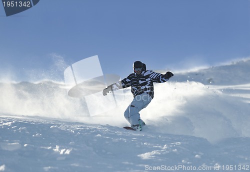Image of freestyle snowboarder jump and ride