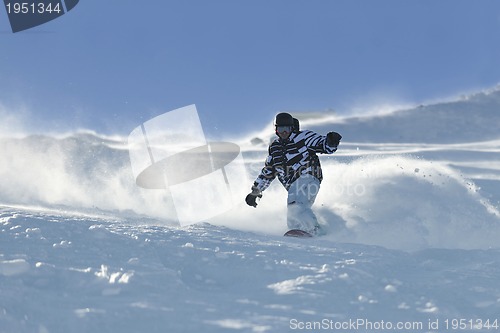 Image of freestyle snowboarder jump and ride