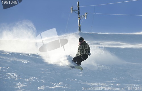 Image of freestyle snowboarder jump and ride