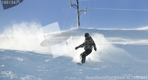 Image of freestyle snowboarder jump and ride