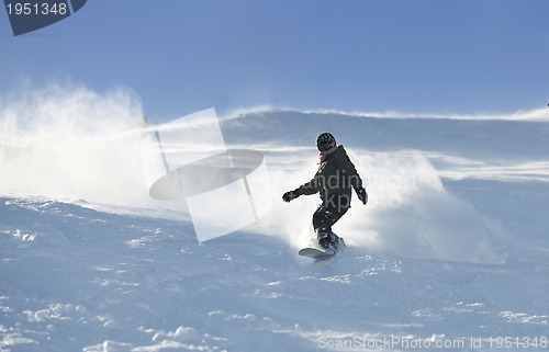 Image of freestyle snowboarder jump and ride