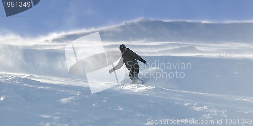 Image of freestyle snowboarder jump and ride