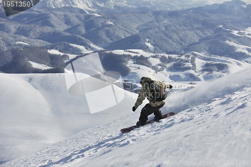 Image of freestyle snowboarder jump and ride