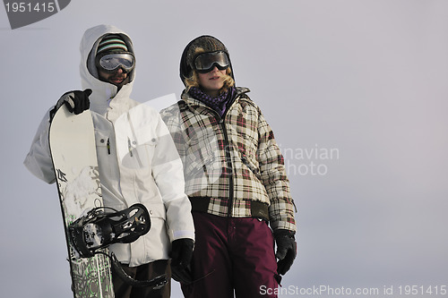 Image of snowboarder's couple on mountain's top