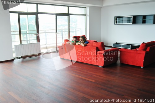 Image of happy couple relax on red sofa 