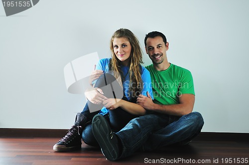 Image of happy couple in empty apartment