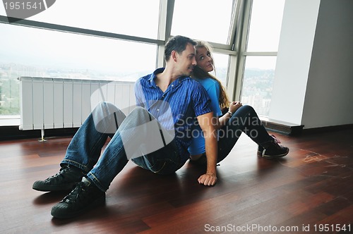 Image of happy couple in empty apartment