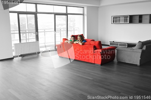 Image of happy couple relax on red sofa 