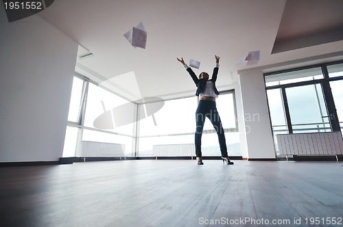 Image of young business woman throw papers in air