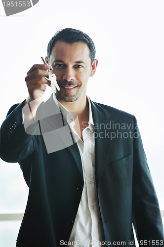 Image of isolated business man hold keys