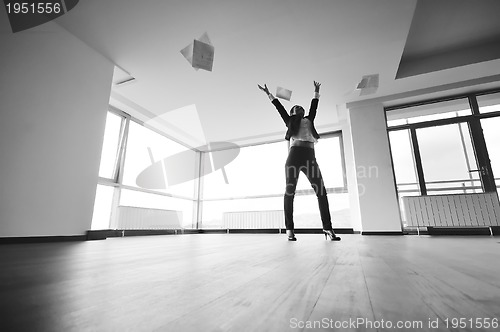 Image of young business woman throw papers in air