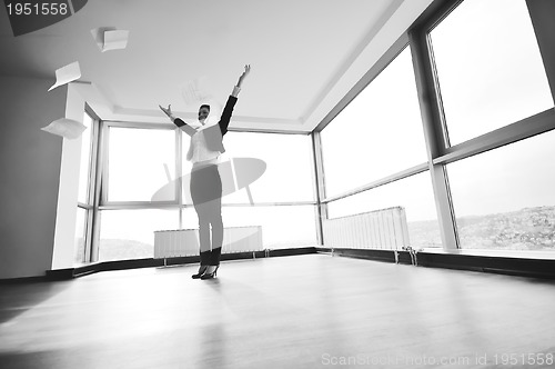 Image of young business woman throw papers in air
